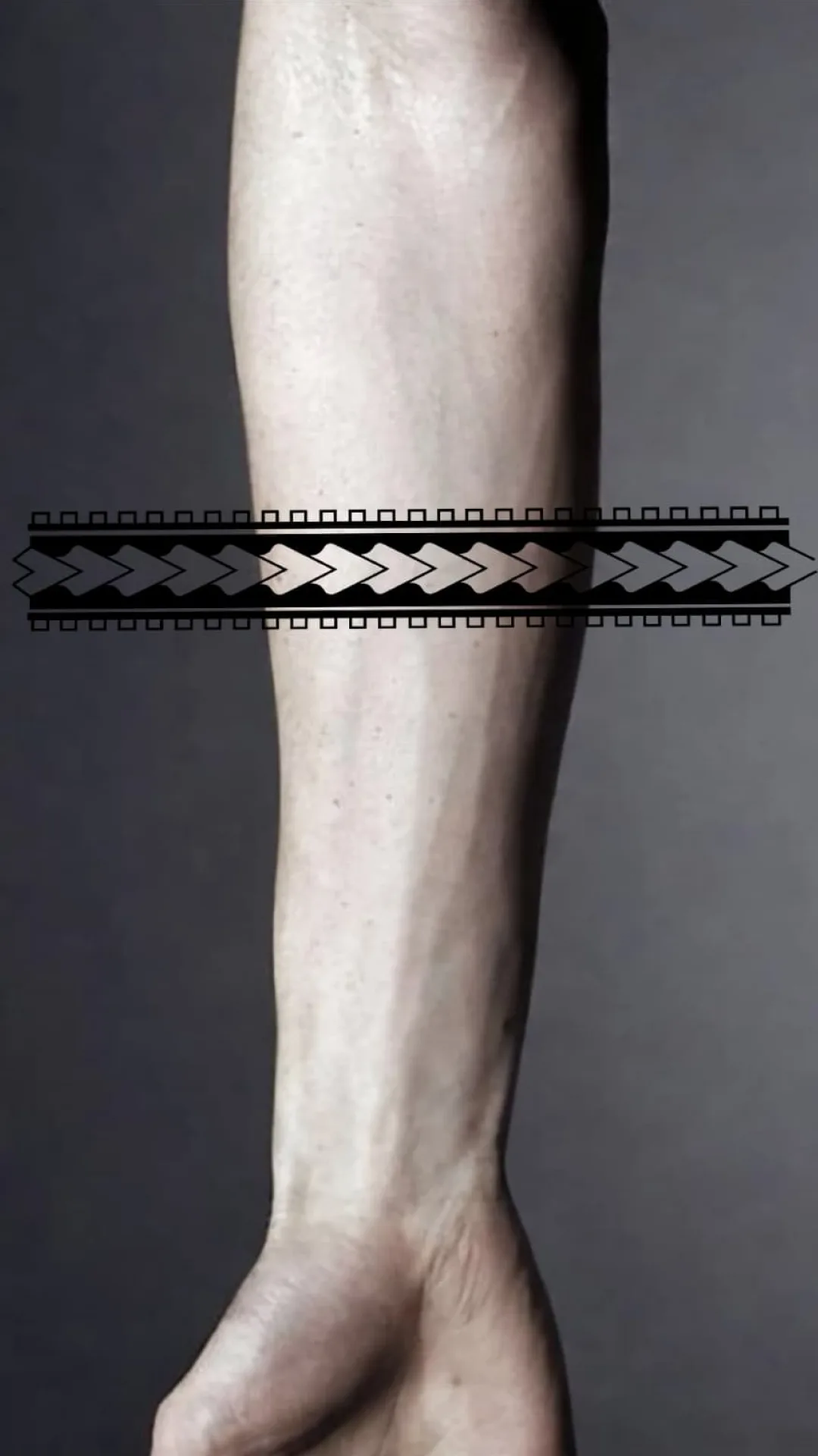 Tattoo stencil placed flat across a leg before fit-to-body adjustment